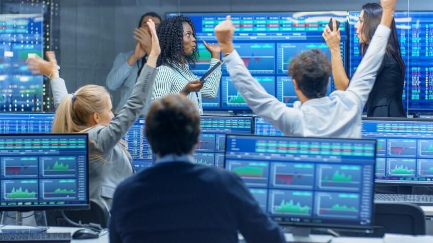 investment analysts celebrating after great trading day
