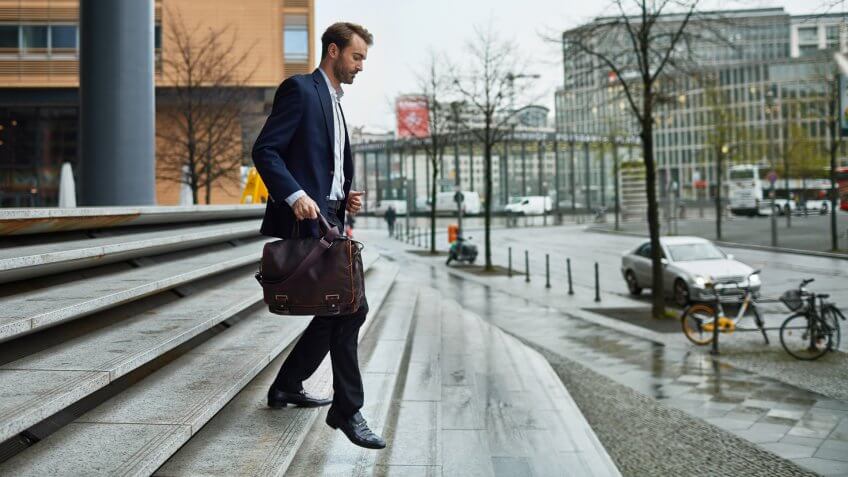 Mid adult men leaving work back home.
