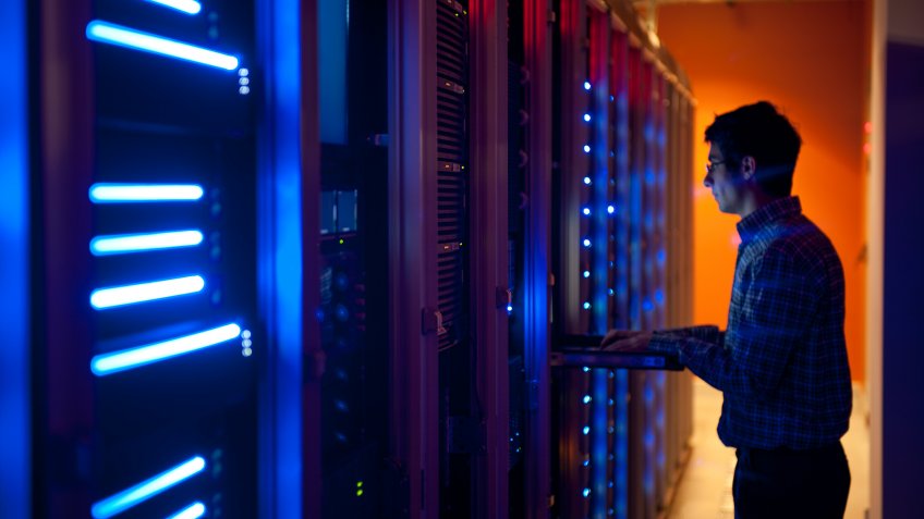 The interior of a modern server room in a data center.
