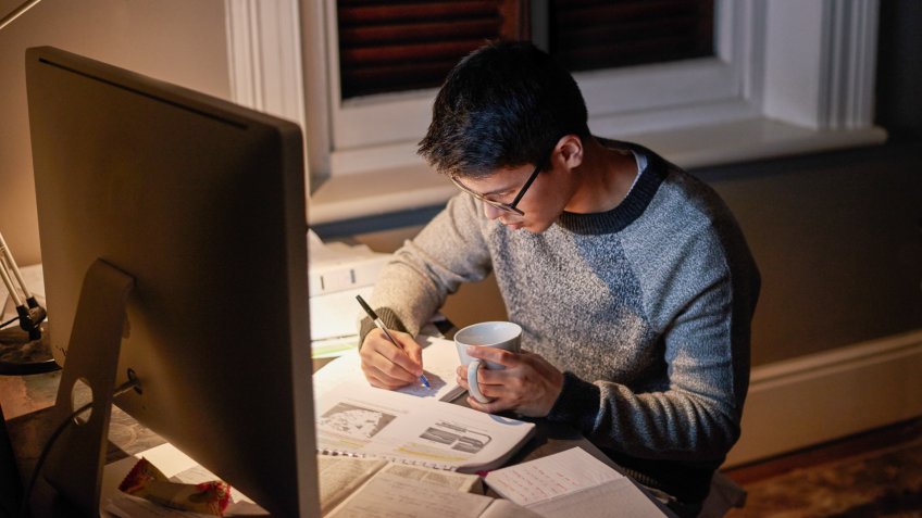 Cropped shot of a young student studying late into the nighthttp://195.