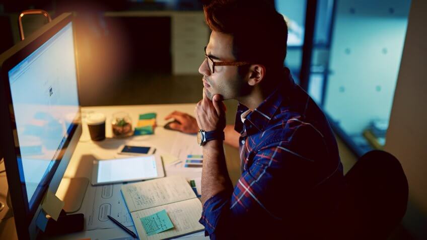 young businessman using a computer during a late night at work.