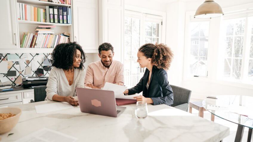 Couple speaking to their accountant.