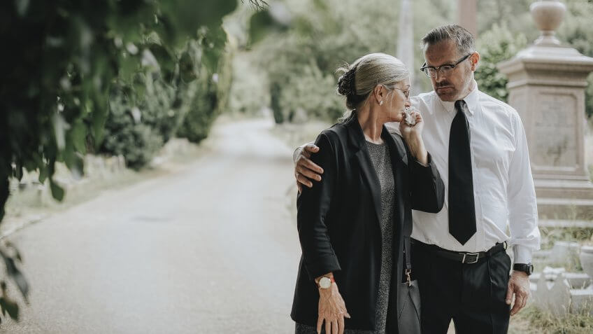 Husband trying to comfort his wife due to her loss.