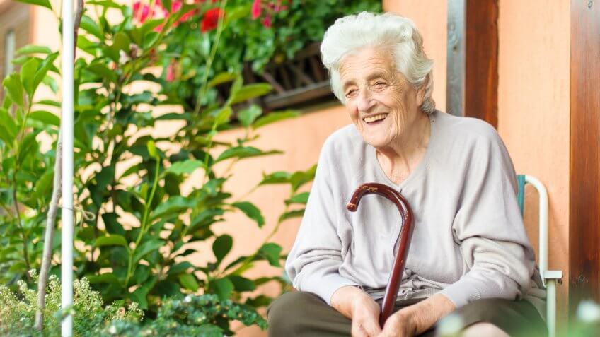 old woman sitting in her garden