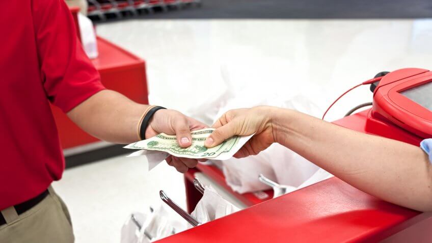 Woman receiving cash back with receipt at a department store