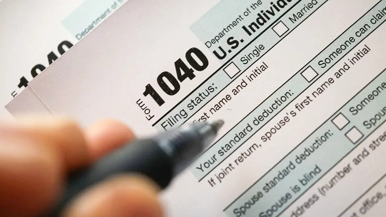person filling out tax form 1040