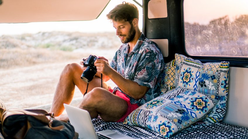 Smiling man using mobile phone.