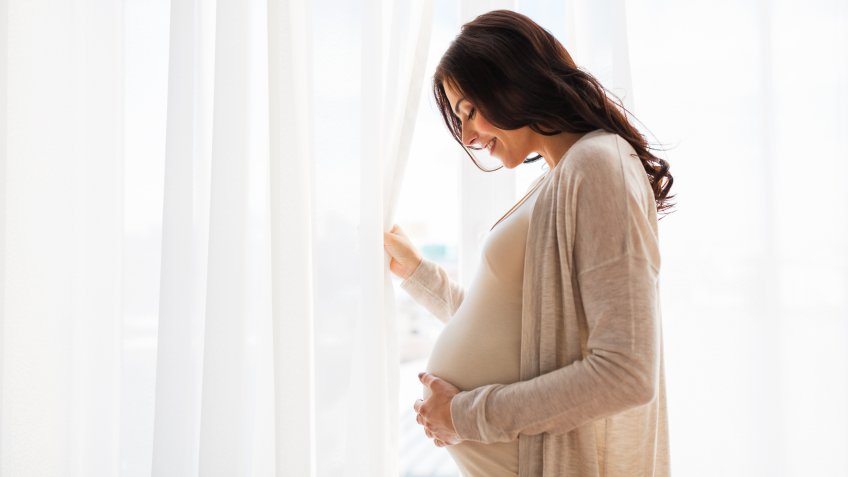 pregnant woman touching her stomach
