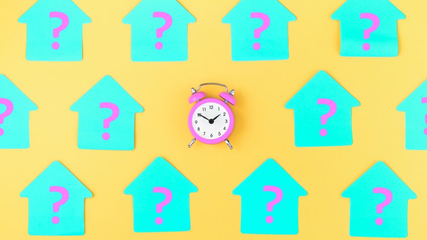 On a yellow background are glued blue stickers on which are written pink question marks.