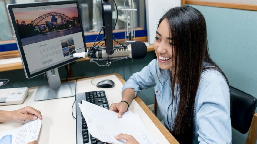Female student broadcasting from a radio station