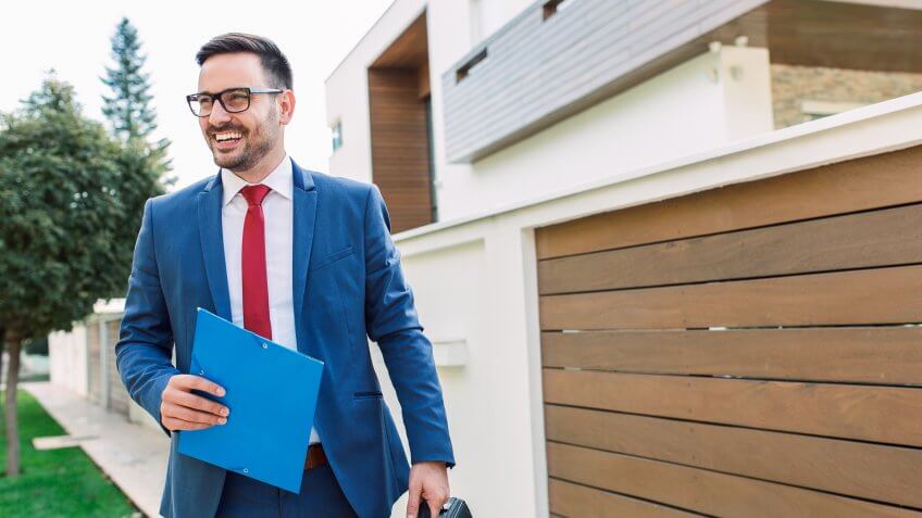 Smiling modern young businessman going to work.