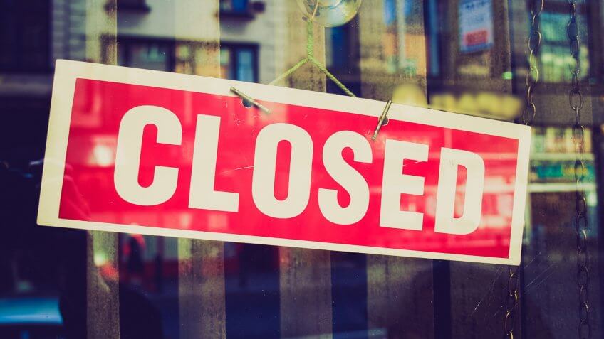 red closed store sign on door