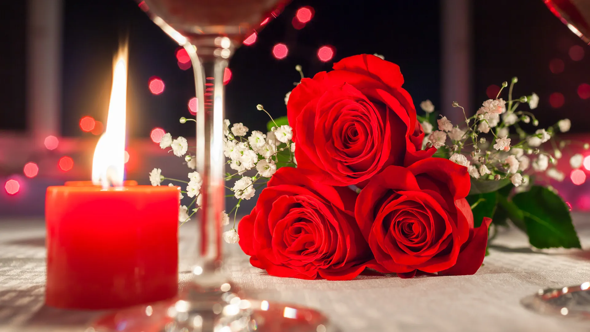 Red roses and candlelight romantic dinner setting.