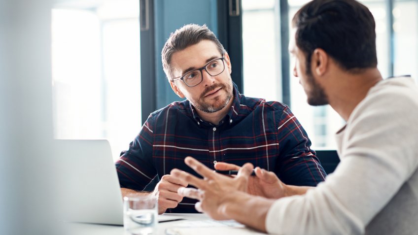 Shot of two businessmen having a discussion in an office.