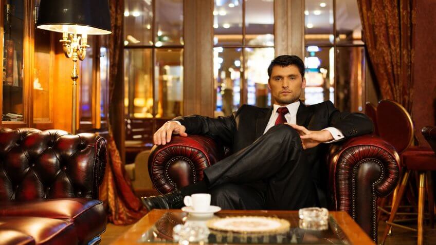 successful businessman sitting in hotel lounge