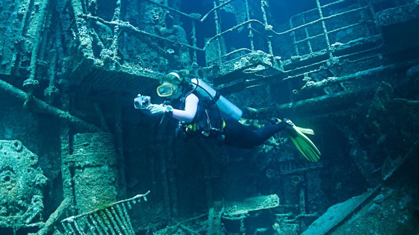 Diver exploring the interior of a shipwreck called Chrisoula K in Abu Nuhas, Red Sea.