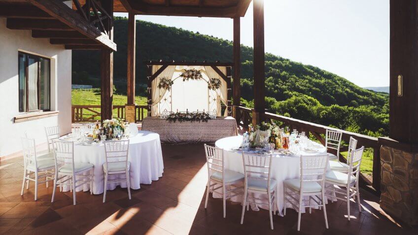 Beautiful decorated wedding ceremony outdoor with mountain view.