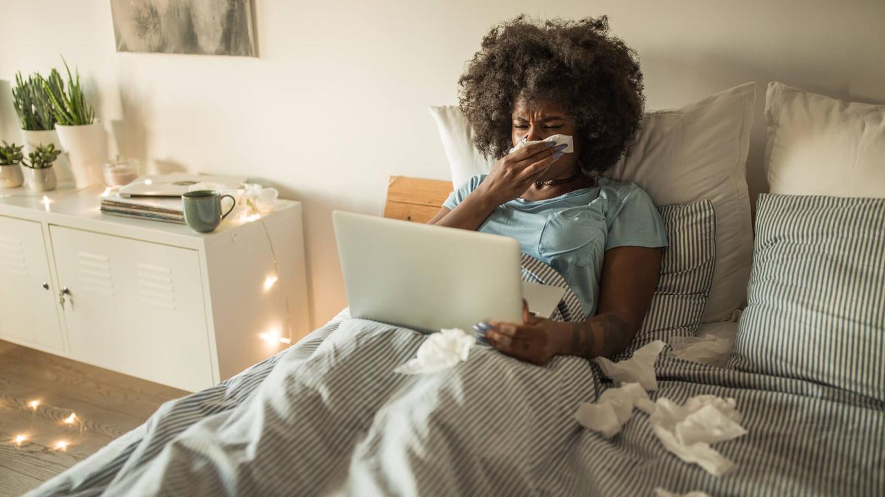 Young African-American woman feeling sick at home.
