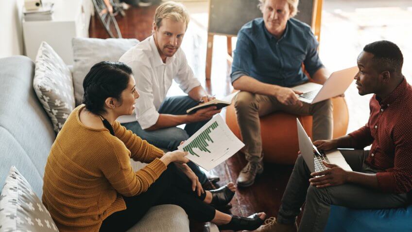 Shot of a diverse group of designers brainstorming together in an office.