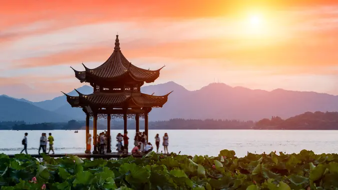 ancient pavilion building of Hangzhou west lake at dusk, in China.