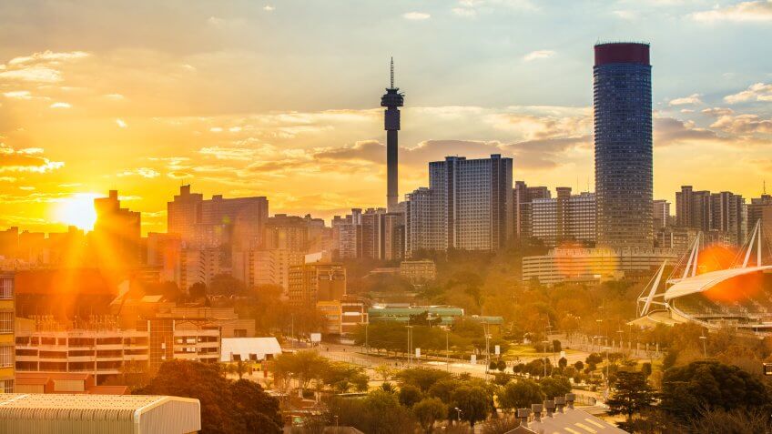 Johannesburg cityscape, taken at sunset, showing Hillbrow residential centre with the prominent Ponte flats and the communications tower.