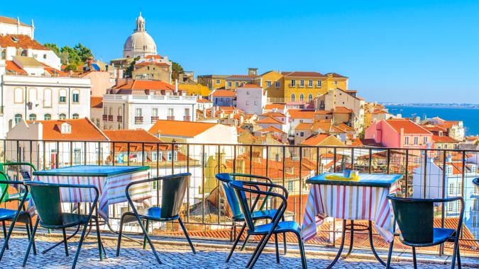 Open café tarrace with breathtaking view at Alfama - historical city-center of Lisbon, Portugal.