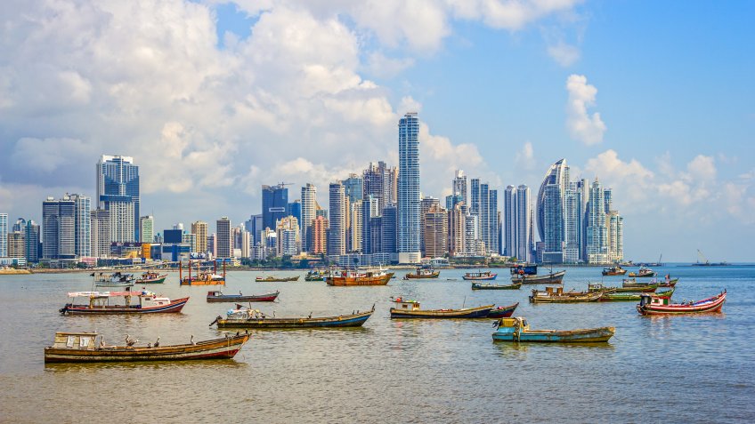 Photo of the skyline of Panama City and harbor with many fishing boats in the Republic of Panama.