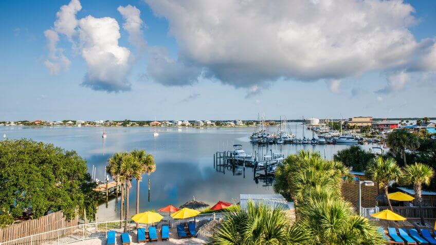 Beautiful colorful morning scene of a marona in Pensacola, Florida with fluffy clouds.