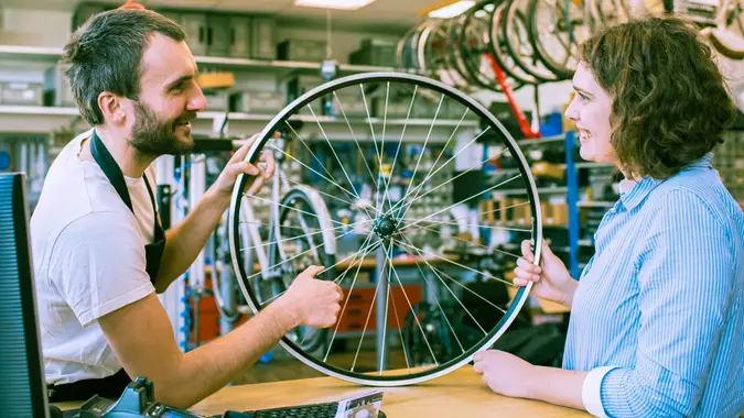 customer and dealer in bicycle shop - purchase and repair of bicycles - customer service.