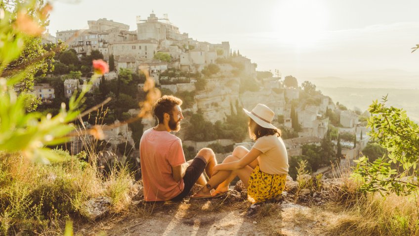 Young Caucasian woman and man looking at scenic view of Gordes village in Provence.