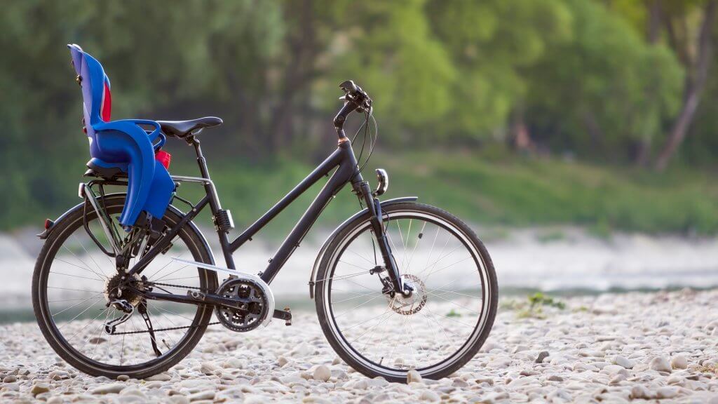 black bicycle with blue plastic child seat