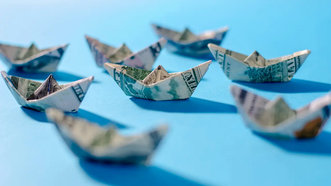 boat money sailing on blue background