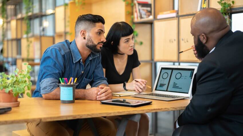 Consultant giving some advice for customer at business meeting.