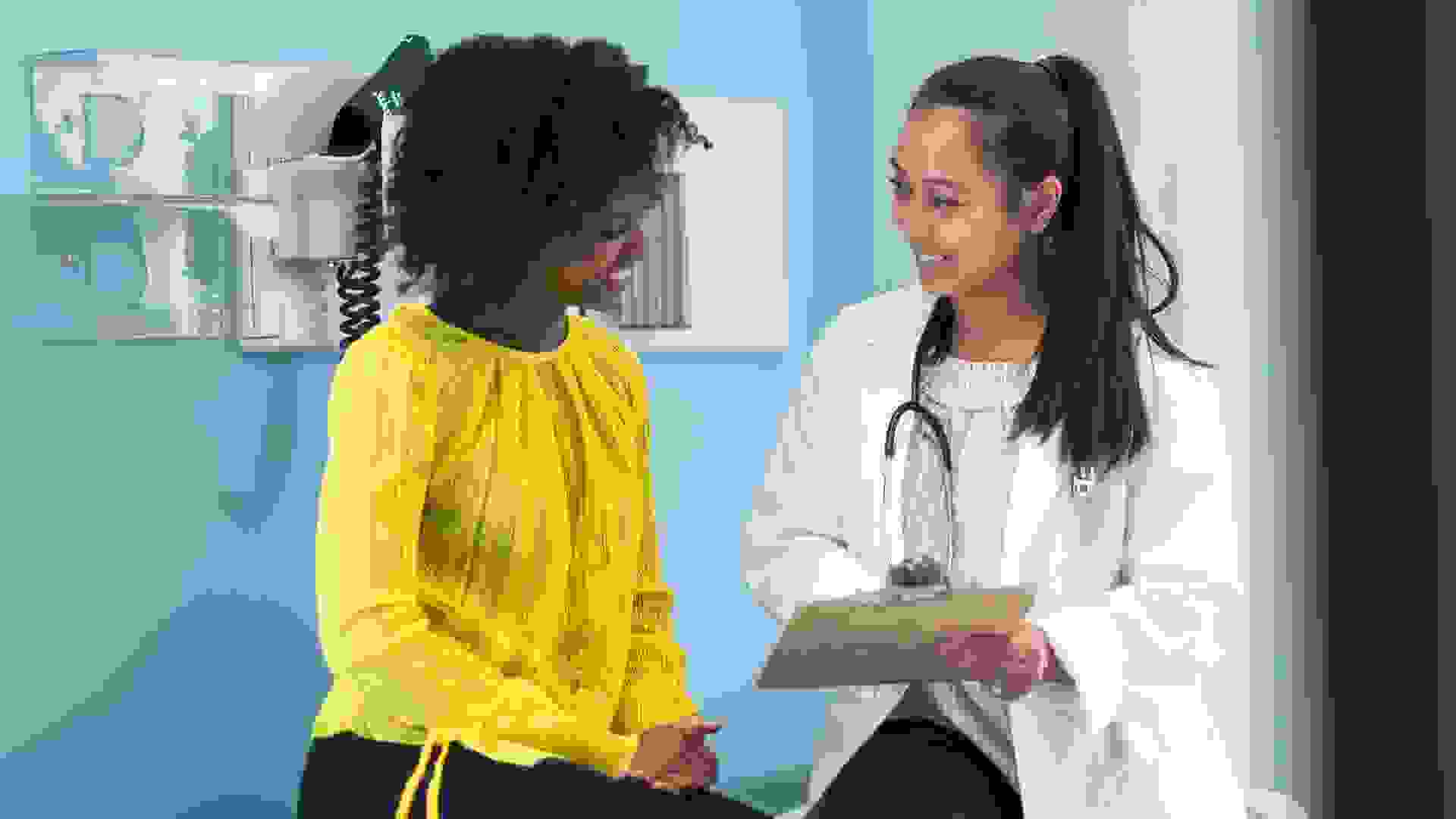 A young black woman is at a routine medical appointment.