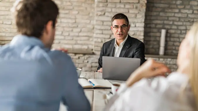 Insurance agent having a meeting with his customers in the office.