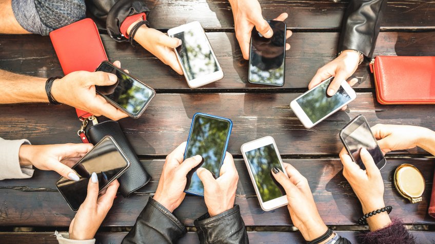 People group having addicted fun together using smartphones - Detail of hands sharing content on social network with mobile smart phones - Technology concept with millennials online with cellphones.
