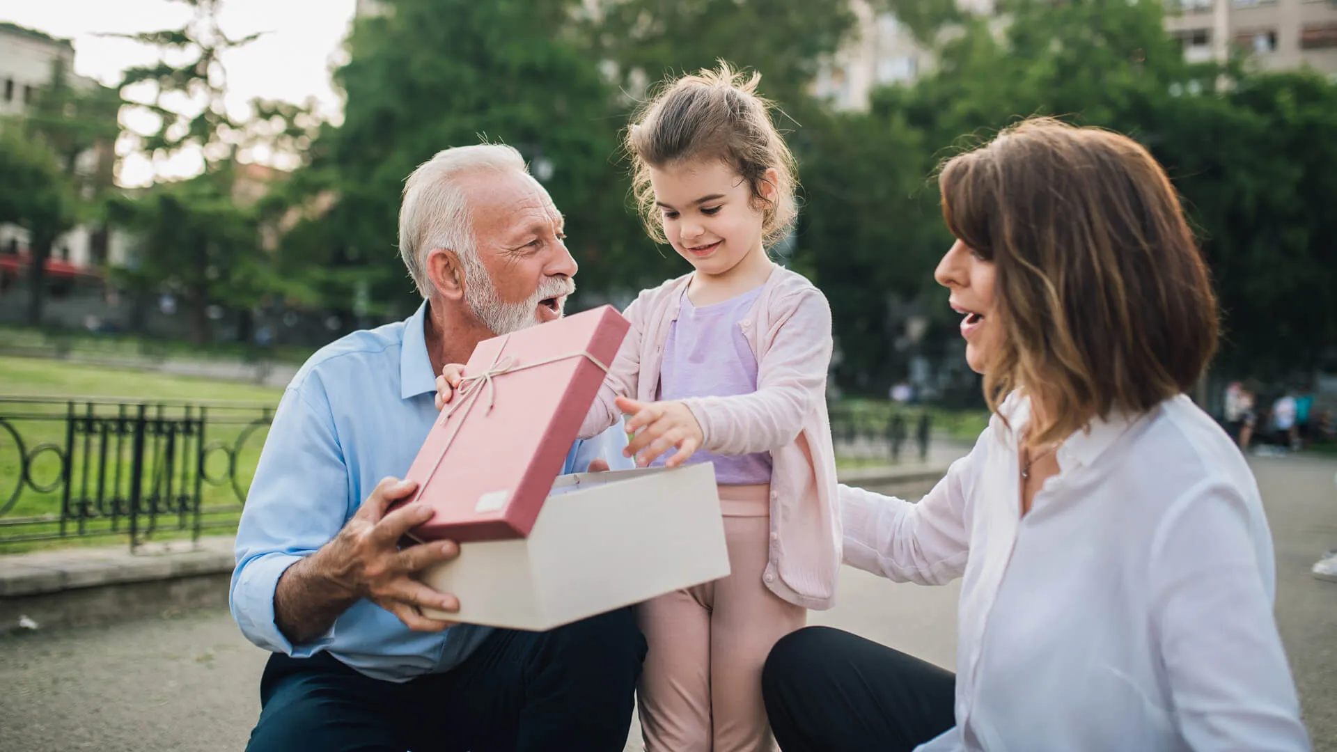 Senior couple with a present for their granddaughter.