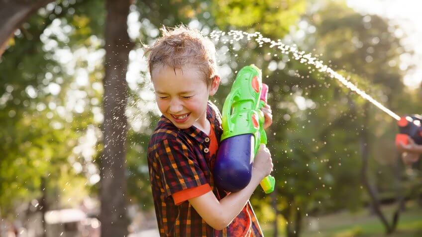 happy boys playing with water guns