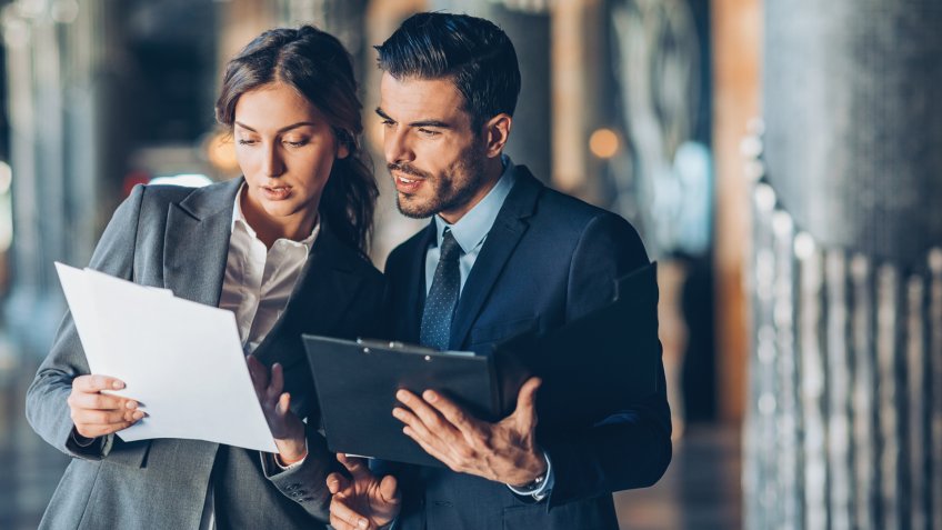 Business persons looking at documents.