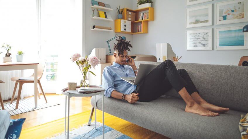 Young man working at home.