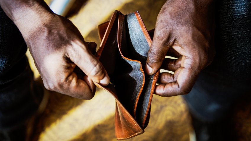 man with empty wallet because he's broke with no money