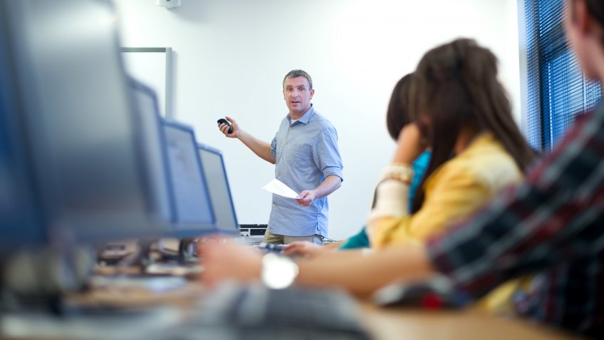 20s, 40s, Adult, Candid, Caucasian, Cheerful, Classroom, College Student, Communication, Computer, Computer Keyboard, Computer Lab, Computer Monitor, Content, Discussion, Education, Ethnic, Global Communications, Group Of People, Happiness, Instructor, Learning, Listening, Male, Mature Adult, Men, Multi-Ethnic Group, Presentation, Real People, Smiling, Student, Talking, Teacher, Technology, Typing, University, Women, female, people, training