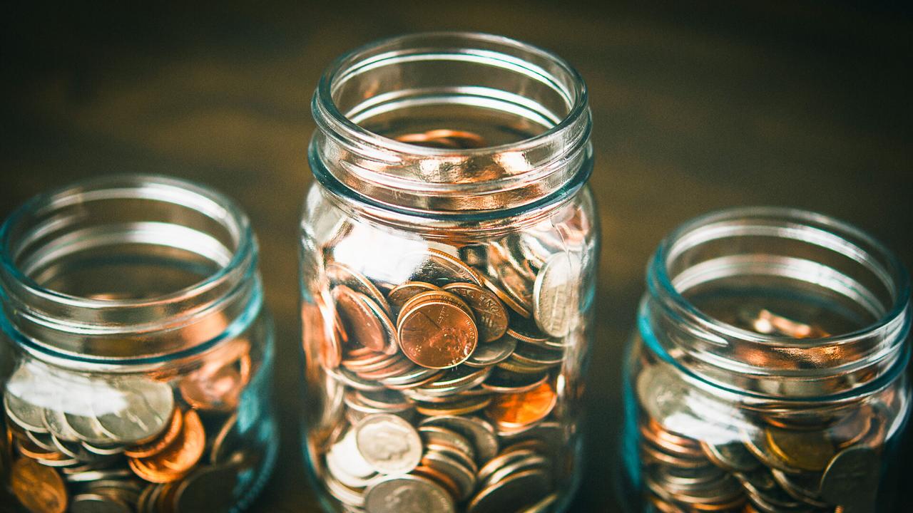 Money jars filled with American currency.