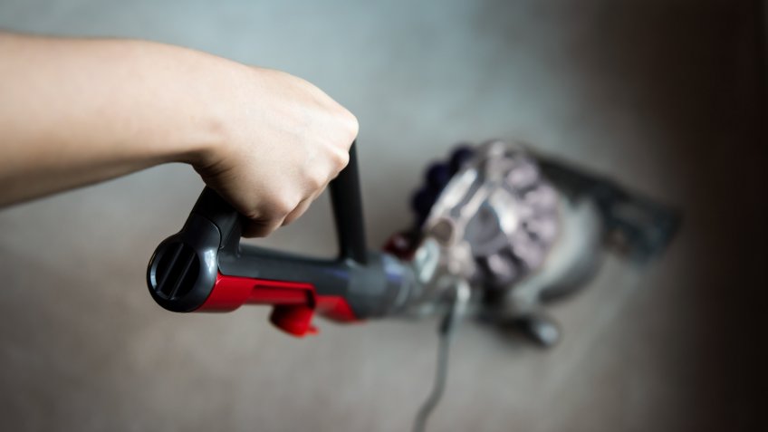 person vacuuming the floor