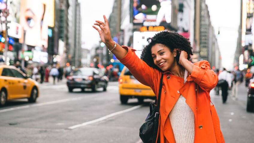 Woman looking for a taxi in New york city.