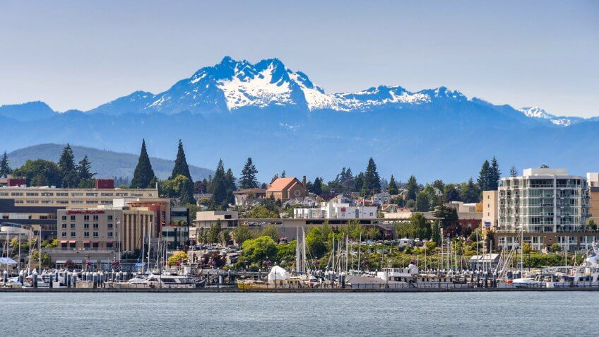 BREMERTON, WASHINGTON STATE, USA - JUNE 2018: Wide angle view of the marina and waterfront in Bremerton, WA, with a backdrop of snow cappped mountains.