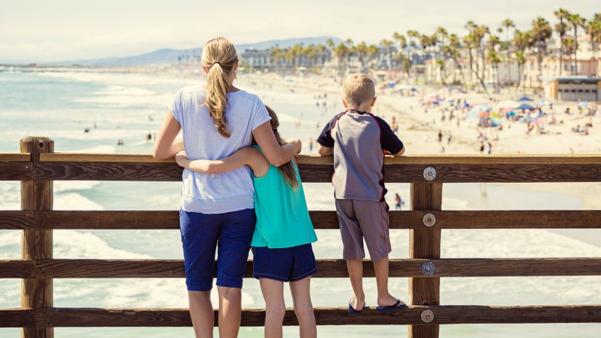 Young family hanging out on an ocean pier on vacation in Southern California - Image.