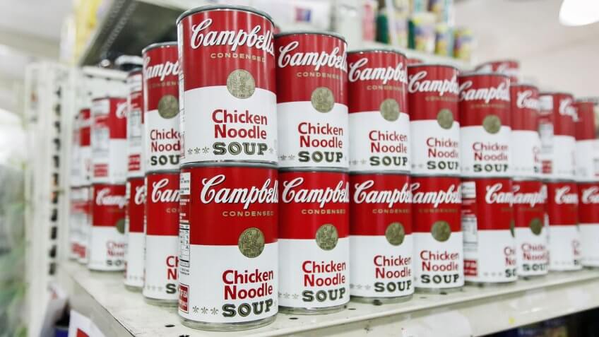 Cans of Campbell's Chicken Noodle Soup on grocery shelf