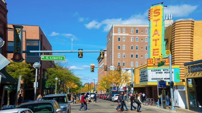 Ann Arbor, United States - October 18, 2015: Pedestrians crossing State Street in Downtown Ann Arbor, Michigan with State Theater on the right.