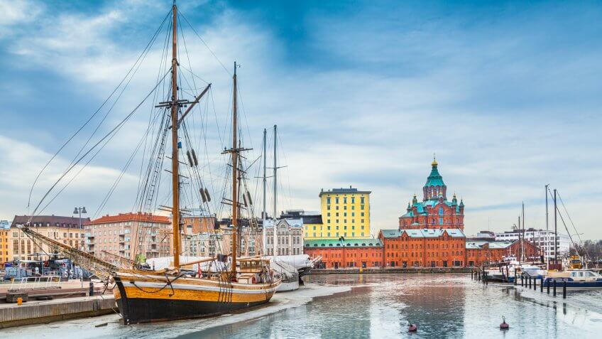 Beautiful view of the old town of Helsinki with famous Uspenski eastern orthodox cathedral church and old port in Katajanokka district of Helsinki on a cold day in winter, Finland.